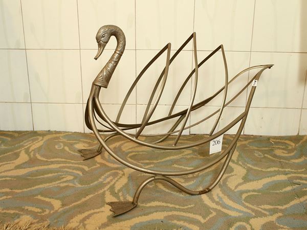 Metal magazine rack shaped like a swan