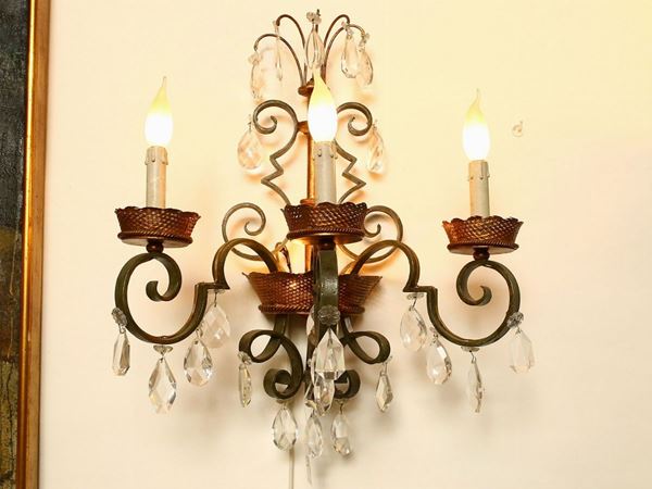 A pair of wrougth iron and crystal sconces