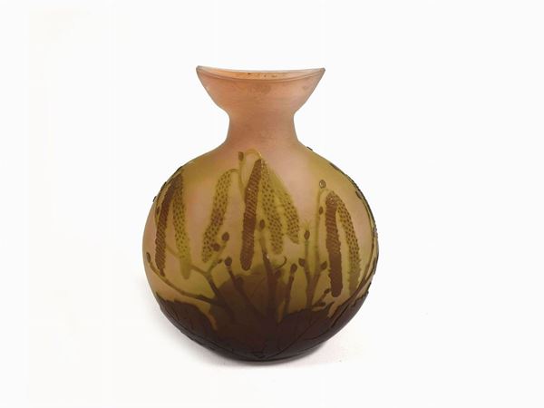 Gallé glass vase with cameo vegetable decoration in shades of green on a  salmon-cloudy background.