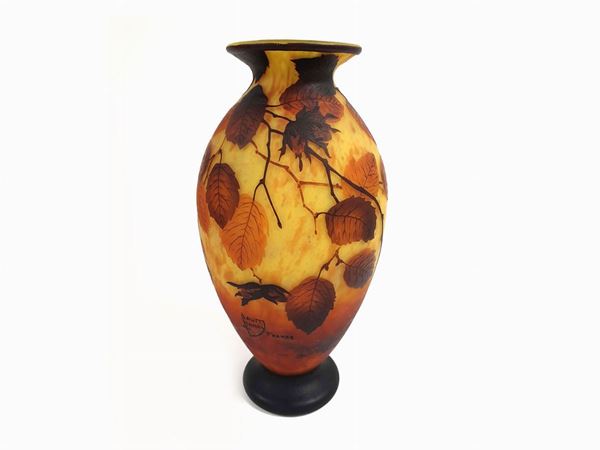Large Daum glass vase decorated with leaves and stone fruits. Signed.
