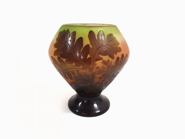 Gallé glass vase with cameo oak leaves decoration in shades of brown on orange background. Signed.