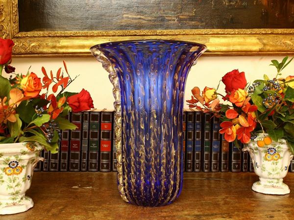 A Toso vase in blue glass with diffused bubbles and lateral  ridges. Signed.