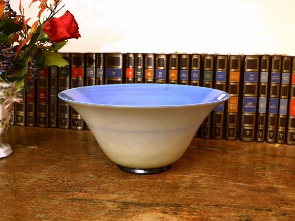 A Venini bowl in blue overlaid glass with gold leaf on the outside. Signed.