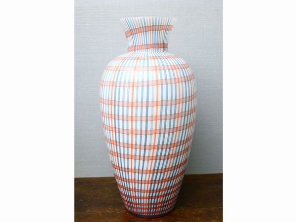 Large milky glass vase with crossed canes coloured in shades of blue and orange.