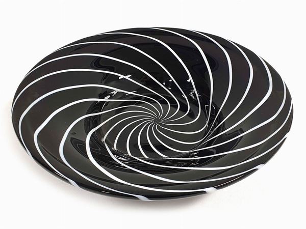 A black glass centerpiece and lattimo reed spiral. Signed.