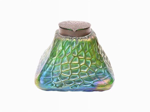 An inkwell in iridescent green glass