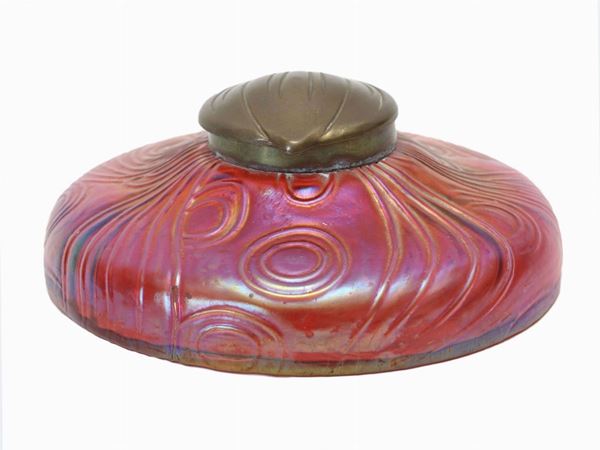An inkwell in red iridescent glass