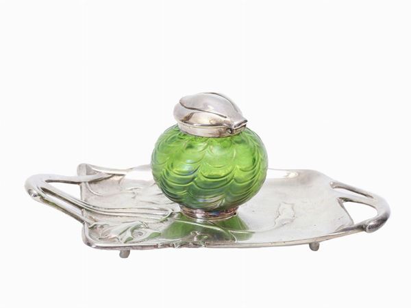 An inkwell in green glass