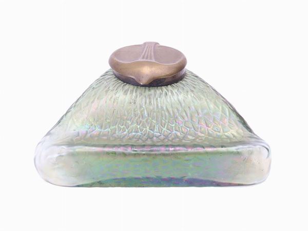 An inkwell in green iridescent glass