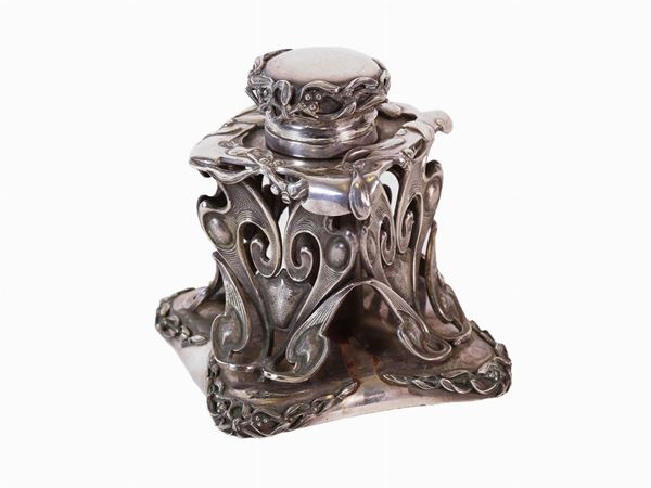 A inkwell in silver metal