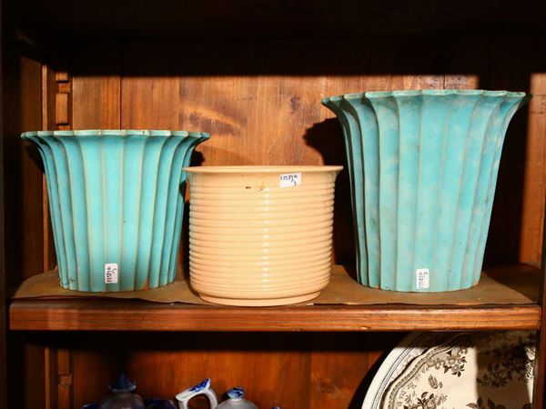 Three glazed terracotta vase holders in shades of turquoise and beige