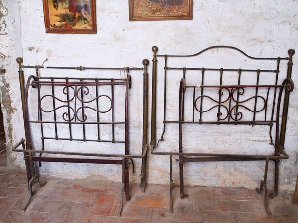 A single bed and a wrought iron sofa