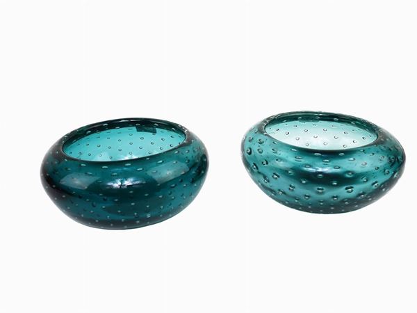 Two green glass ashtrays with diffused bubbles