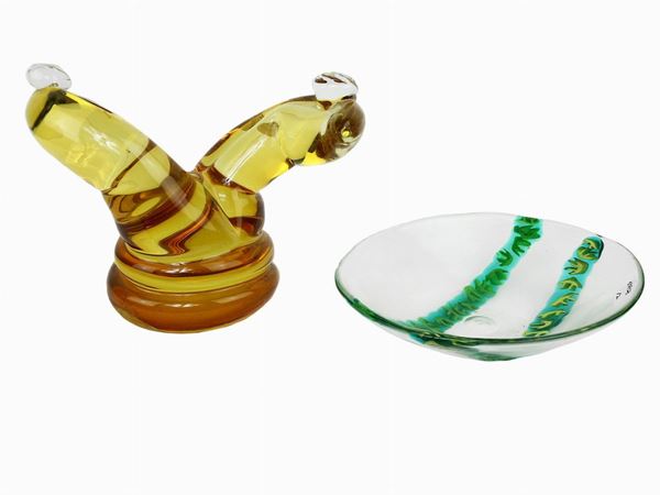 A straw yellow glass sculpture and a bowl