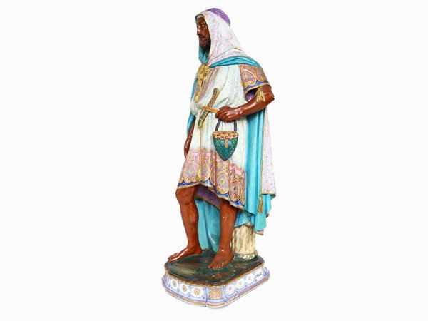 Polychrome biscuit figure depicting a male character