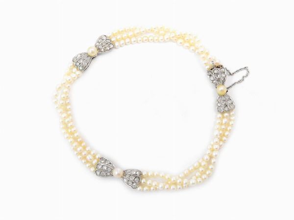 Micro-pearl bracelet with platinum inserts and clasp with diamonds and pearls