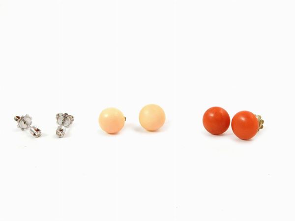 Three pairs of white and yellow gold earrings with diamonds, orange red corals and pink corals