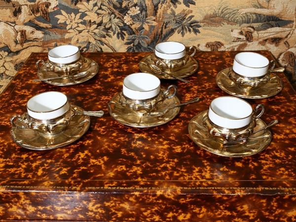 Set of six silver and porcelain coffee cups