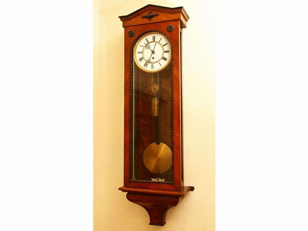 Wall clock in walnut veneer