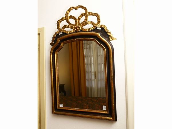 Specchiera in legno intagliato, dorato ed ebanizzato
