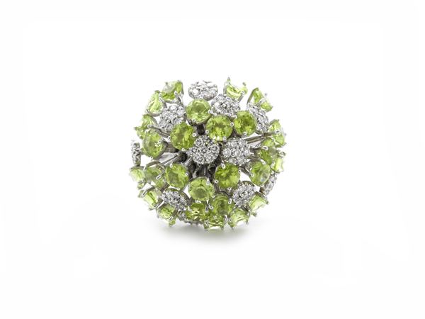 White gold ring with diamonds and peridots
