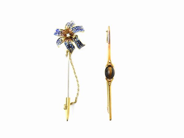 Two yellow gold brooches with diamond, tiger eye quartz and multicolored enamels