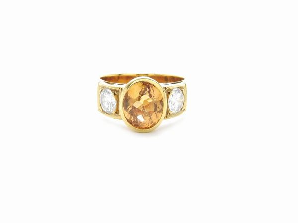 Yellow gold ring with diamonds and imperial topaz