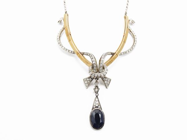 White and yellow gold necklace with diamonds and sapphire