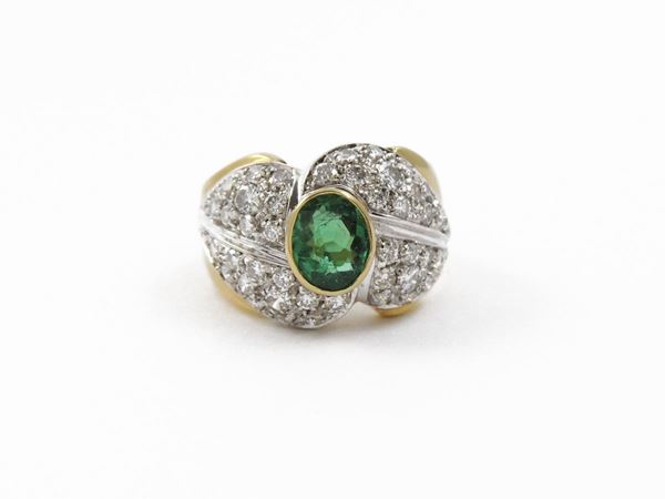 White and yellow gold band ring with diamonds and emerald