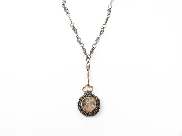 Long chain with portrait pendant in yellow gold and silver and green enamels