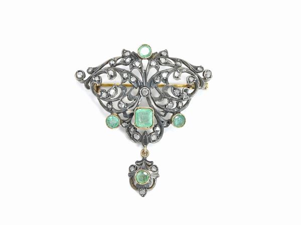 Yellow gold and silver brooch with diamonds and emeralds