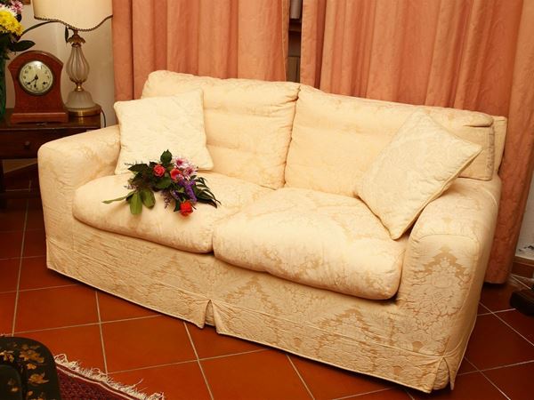 Two seater sofa upholstered and upholstered in cream yellow damask