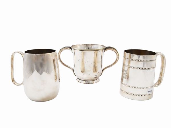 Three silver-plated metal mugs