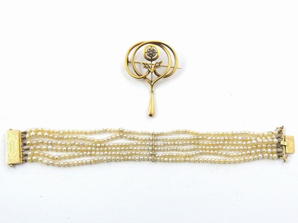A yellow gold micro-pearl brooch and a multi-strand pearl bracelet with yellow gold clasp