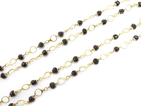 Two yellow gold necklaces with garnets