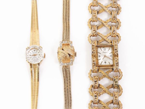 Three golden metal watches
