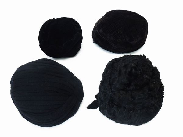 Four caps in black velvet, astrakhan and wool