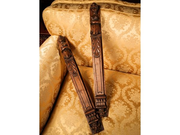 Pair of architectural elements for furniture in carved walnut