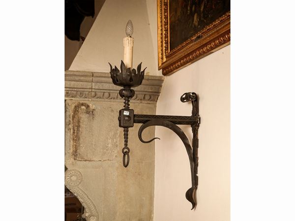 Series of three large applique arms in wrought iron