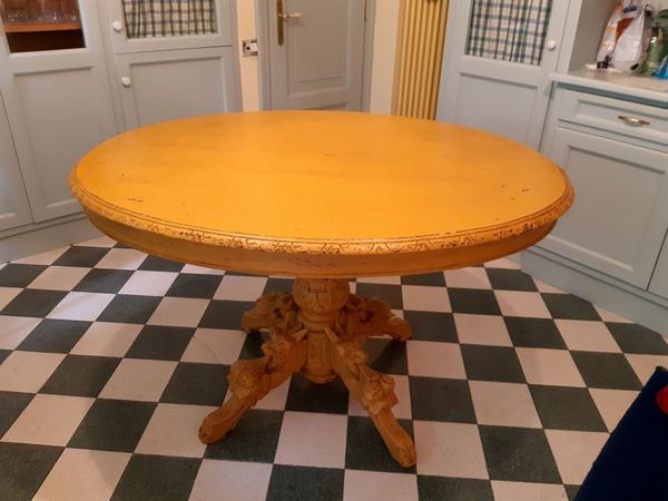 Dining table in ocher lacquered wood