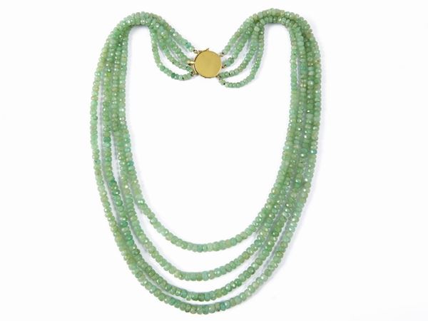 Four-strand stepped necklace of raw green beryls with yellow gold clasp