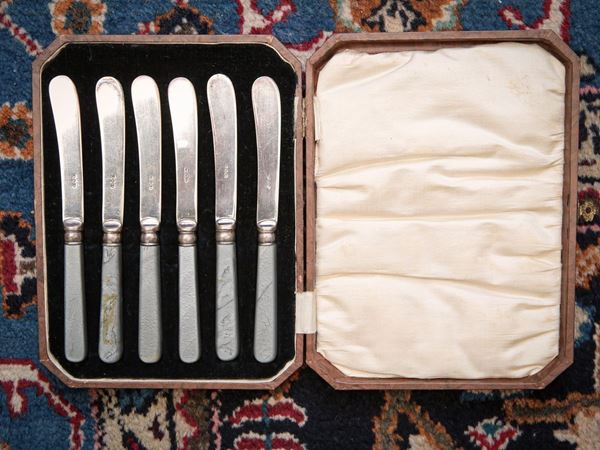 Set of six silver metal butter knives