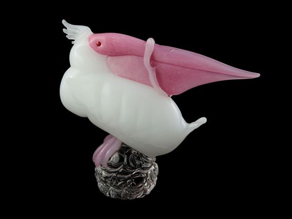Sculpture depicting a pelican in thick milky glass
