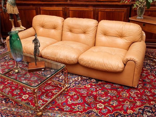 Upholstered three-seater sofa in beige leather
