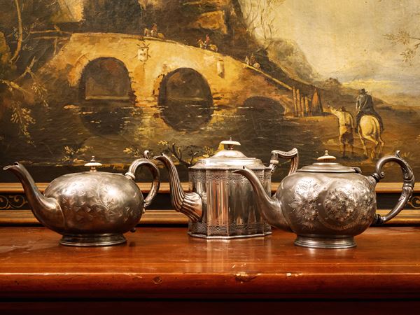 Three silver metal teapots