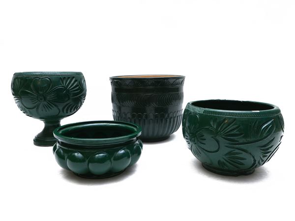 Four dark green terracotta vase holders