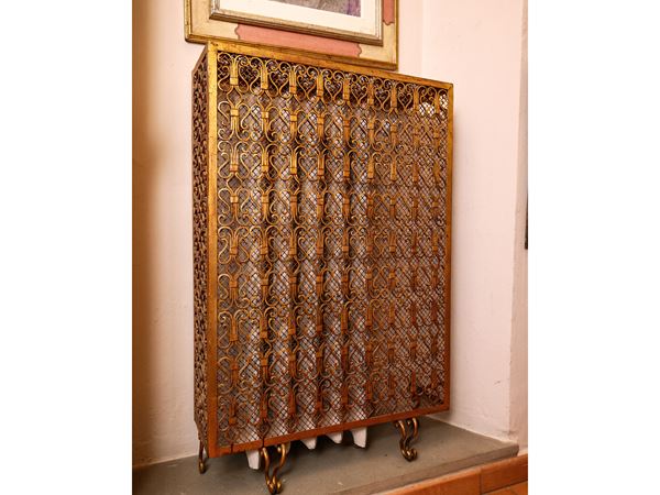 Golden wrought iron radiator cover