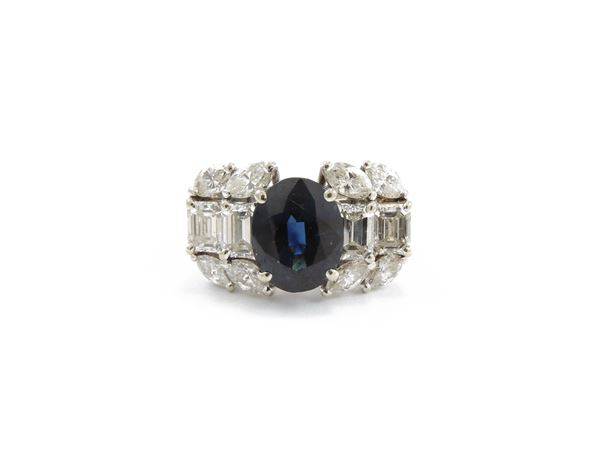 White gold band ring with diamonds and sapphire