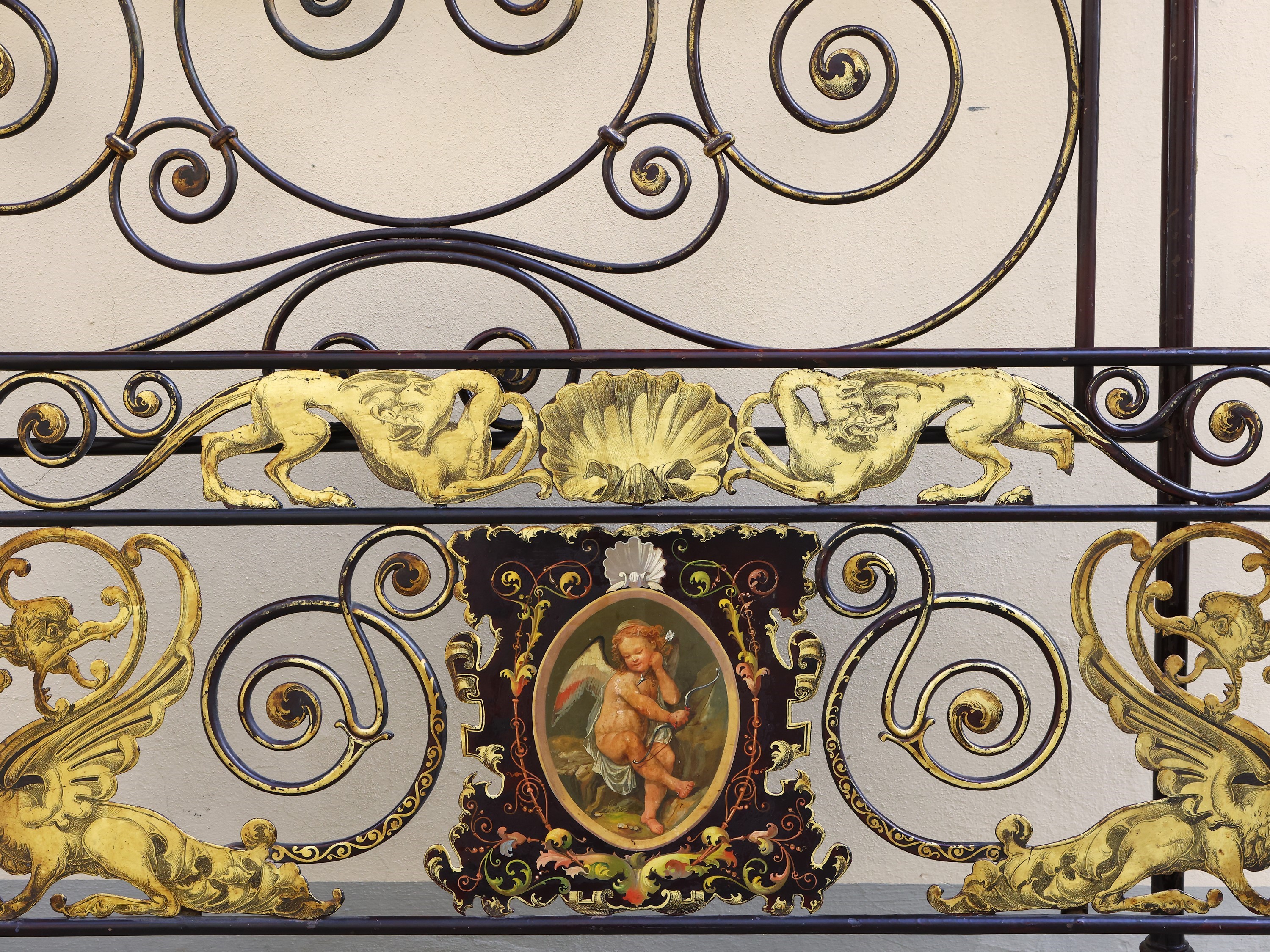 Bel letto singolo in ferro battuto ebanizzato e lumeggiato in oro