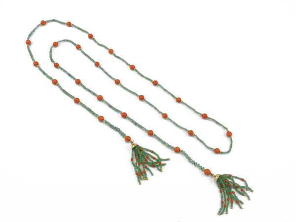 Long string of emeralds and  red orange corals with yellow gold elements